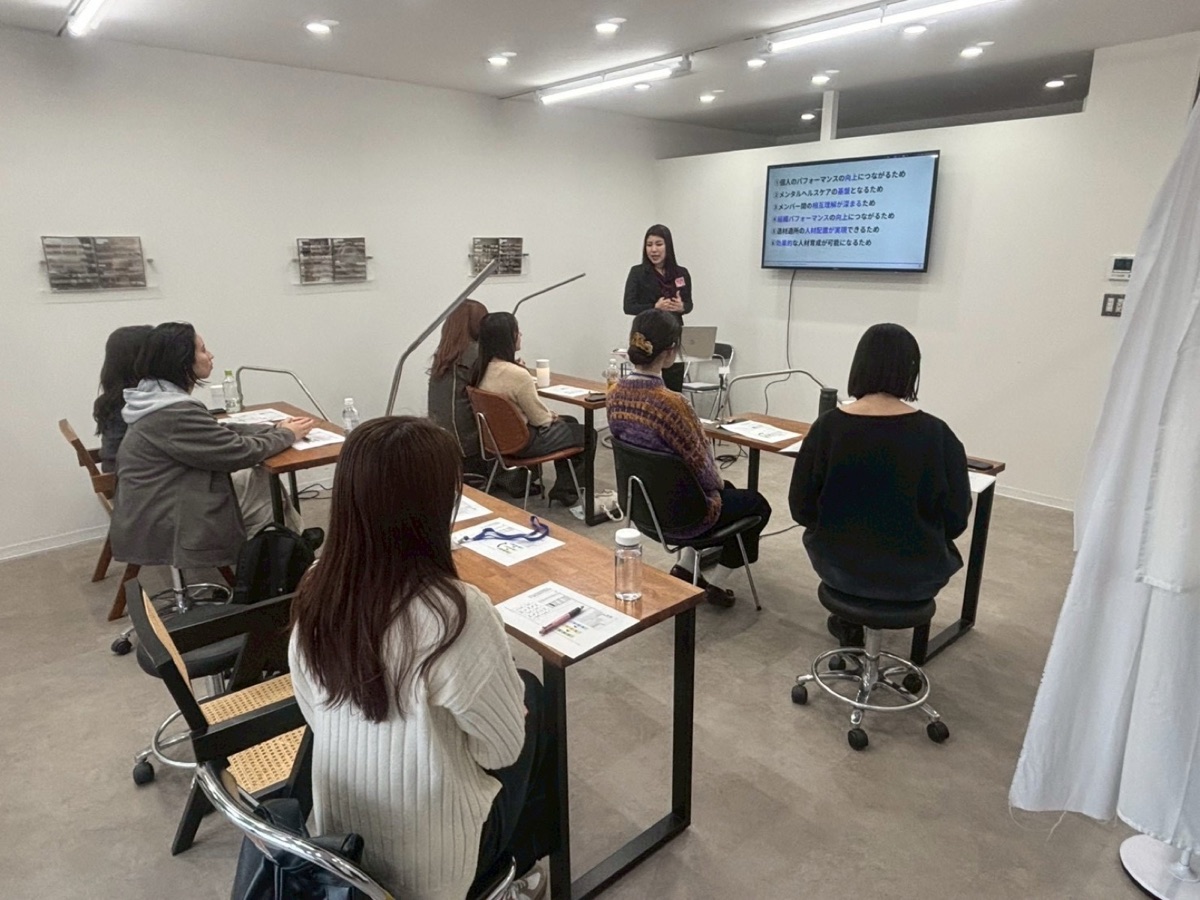 EQ教育の企業研修でスライドを使って講義をする講師と受講者